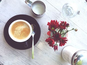 Directly above shot of coffee and flowers on table