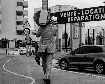 Man standing on street in city