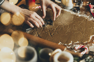 Midsection of person preparing cookies