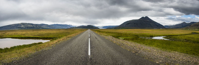 Panoramic view of road amidst mountains against sky