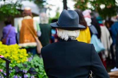 Rear view of man and woman standing on street