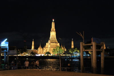 Illuminated temple against sky at night