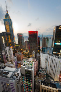 Aerial view of buildings in city against sky