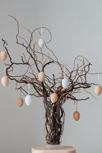 Colored easter eggs on tree branches in vase