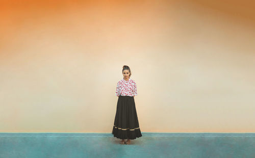 Woman standing against wall