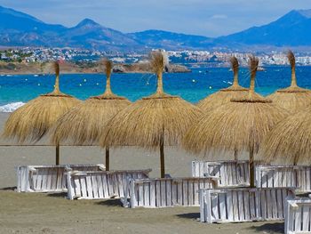 Beach parasols and loungers on the beach in the sunshine on southern spain