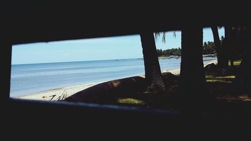 Scenic view of sea against clear sky seen through window