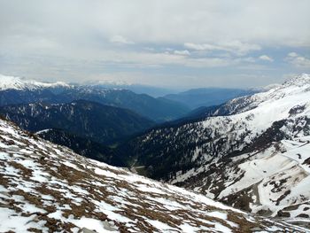 Scenic view of snow covered mountains against sky