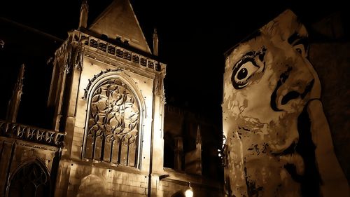 Low angle view of illuminated sculpture against sky at night