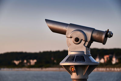 Close-up of coin-operated binoculars against sky