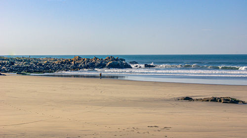 Scenic view of beach against clear sky