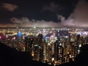 High angle view of city lit up at night