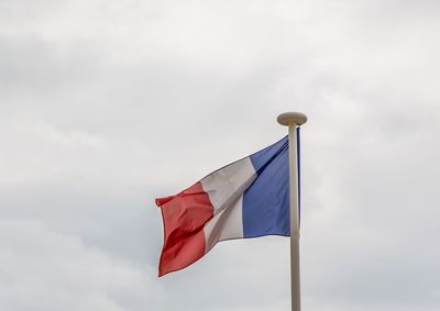 Low angle view of flag against sky