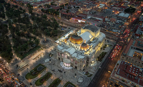 High angle view of illuminated buildings in city at night