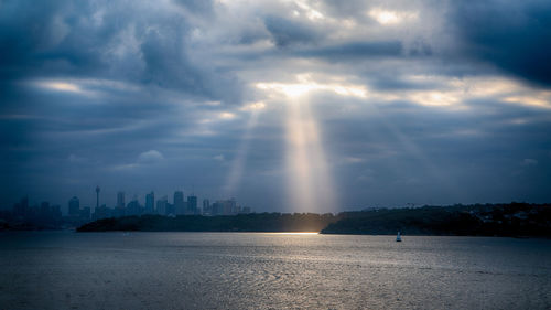 Scenic view of sea and buildings against sky during sunset