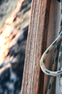 Close-up of rope tied on wooden post