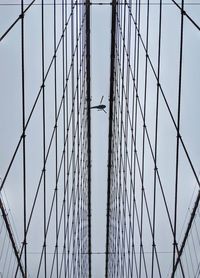 Low angle view of suspension bridge against sky