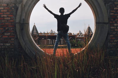 Rear view of man standing on circular structure