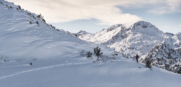 Scenic view of snow covered mountains against sky