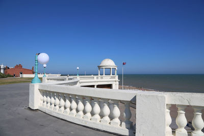 Built structure on beach against clear blue sky