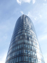 Low angle view of modern building against cloudy sky