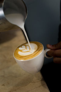 Close-up of hand holding coffee cup