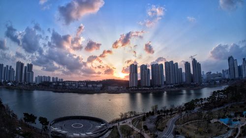 Panoramic view of city skyline against sky during sunset