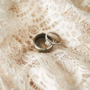 Two silver wedding rings with a lace background. jewelry for an engagement or valentines day
