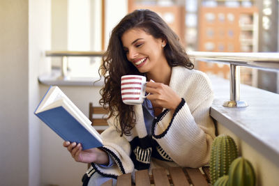 Young woman smiling while sitting at home