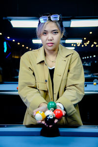 Young woman playing pool