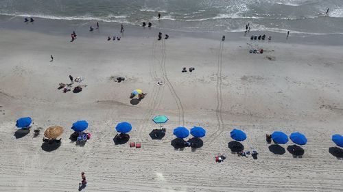 High angle view of people standing on beach