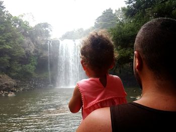 Rear view of two people in rain