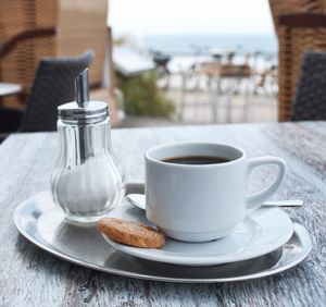 Close-up of coffee and cookie on table