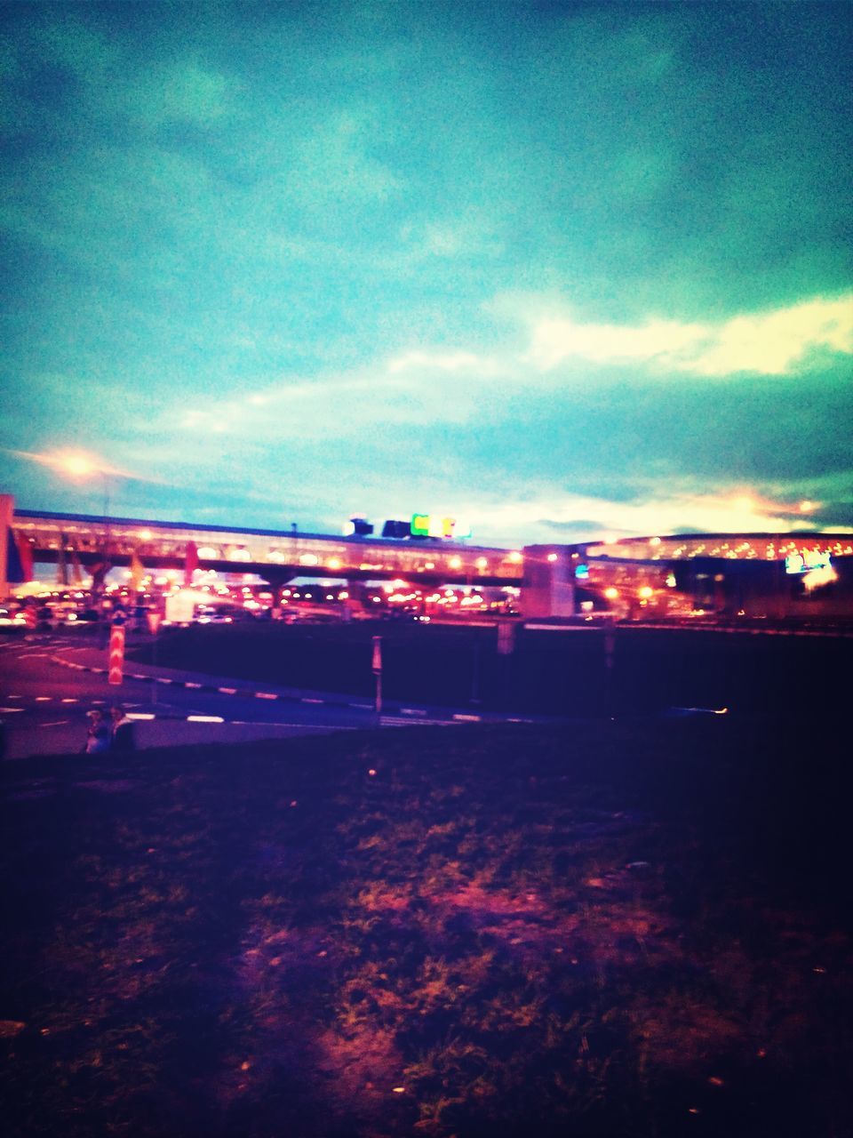 sky, illuminated, cloud - sky, night, architecture, built structure, building exterior, dusk, transportation, cloudy, road, city, sunset, cloud, outdoors, street, red, dramatic sky, multi colored, bridge - man made structure