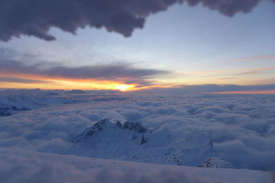 Scenic view of snow landscape against sky during sunset