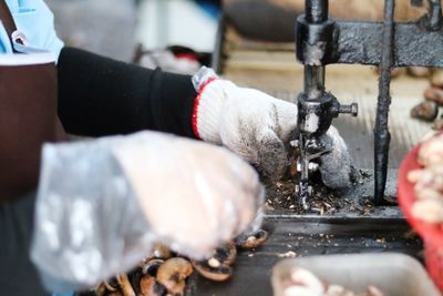 Close-up of man working at machine