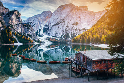 Scenic view of lake by mountains against sky during winter