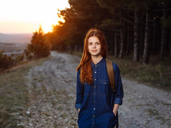 Portrait of teenage girl standing on land