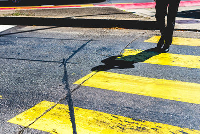 Low section of woman on yellow shadow