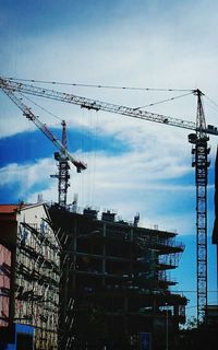 Low angle view of crane against sky