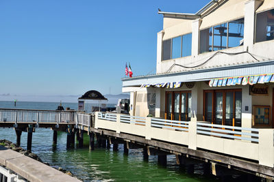 View of pier by sea against clear sky