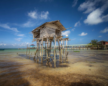Lifeguard hut on beach against sky