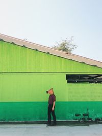 Full length of man standing against building against sky