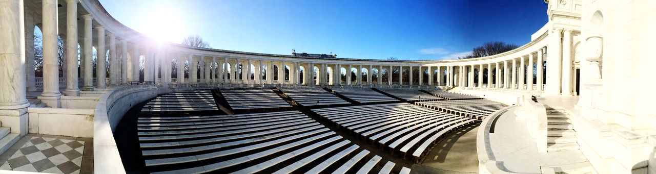 architecture, built structure, sunlight, building exterior, clear sky, sunny, blue, sun, the way forward, sunbeam, arch, sky, diminishing perspective, day, lens flare, low angle view, railing, vanishing point, travel destinations, building