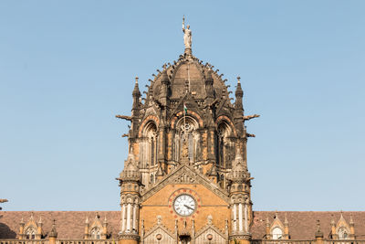 Low angle view of bell tower against blue sky