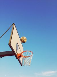 Low angle view of basketball hoop against blue sky