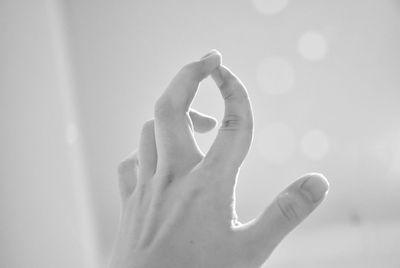 Close-up of woman hand against wall