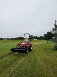 Tractor on field against sky