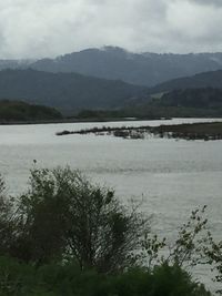 Scenic view of lake and mountains against sky