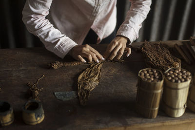 Midsection of woman working on tobacco factory